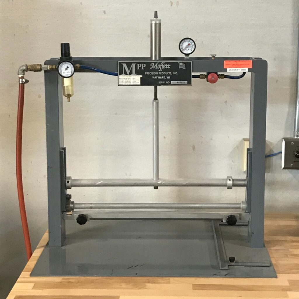 BC Adhesives’ in-house page pull testing machine measuring the adhesive strength of a bound book.